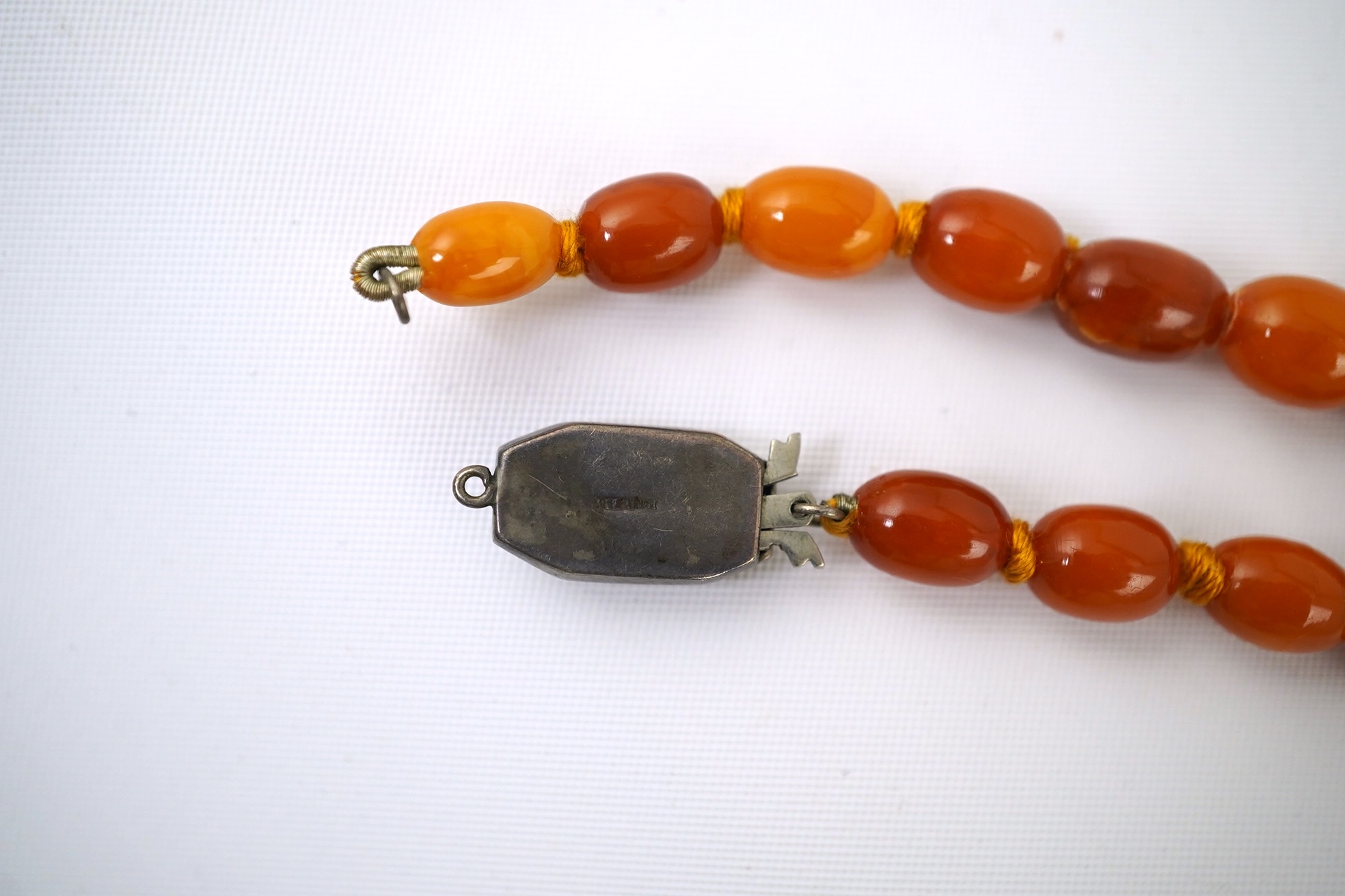 A single strand graduated oval amber bead necklace